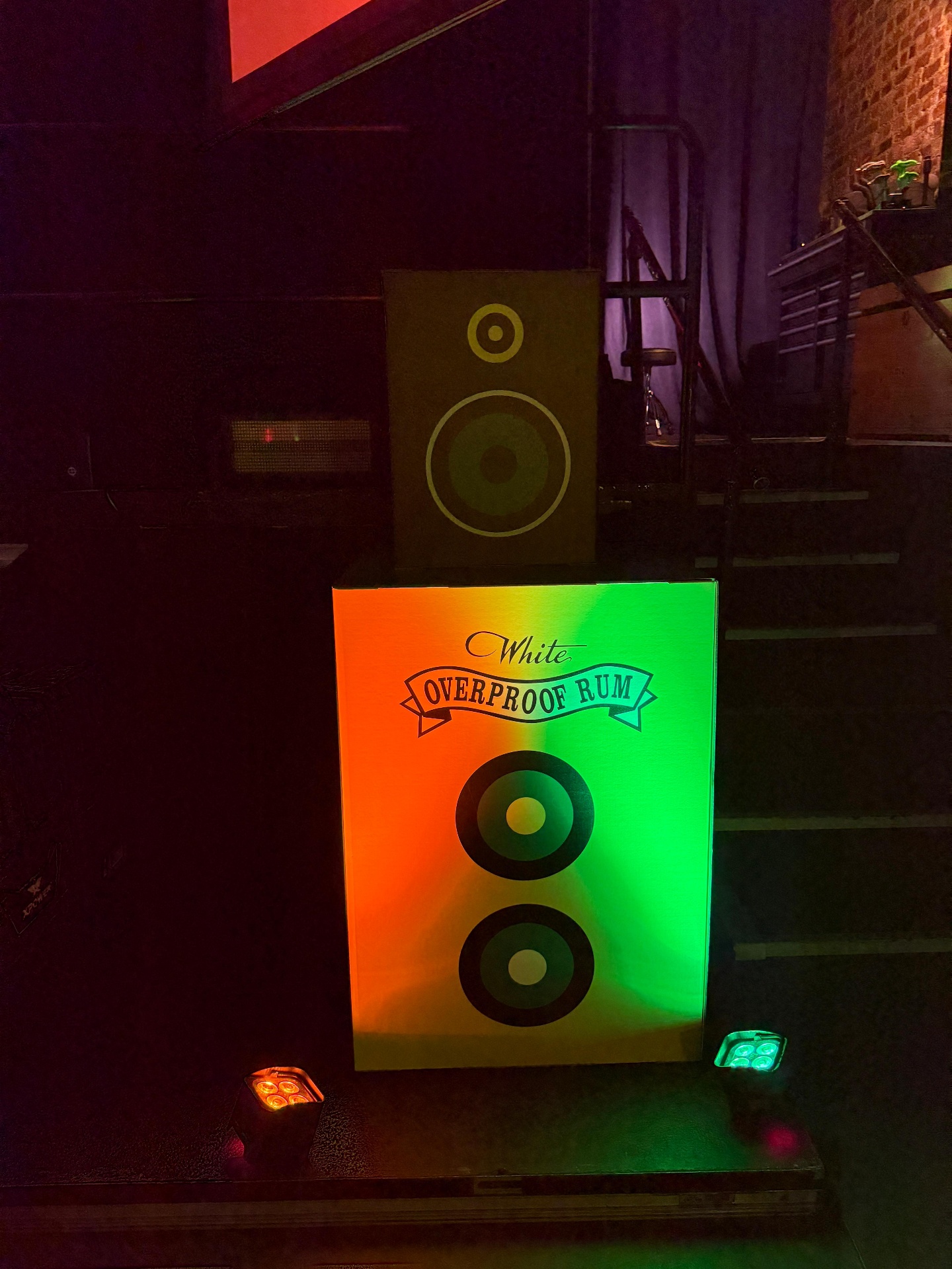 Wray and Nephew Overproof Rum branded speaker totems uplit on the stage edge