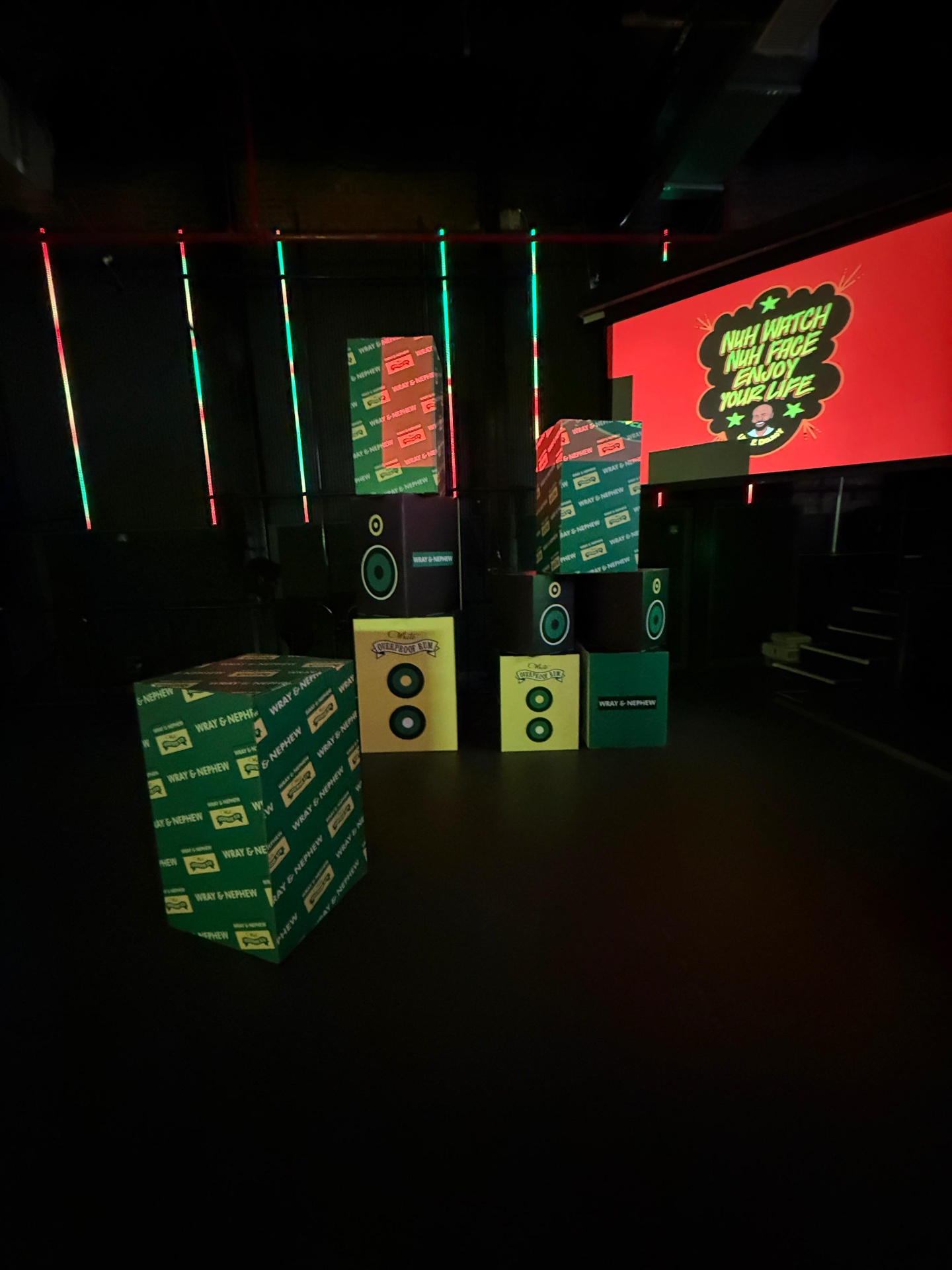 Stacked Wray and Nephew speaker crates and label boxes in the activation footprint
