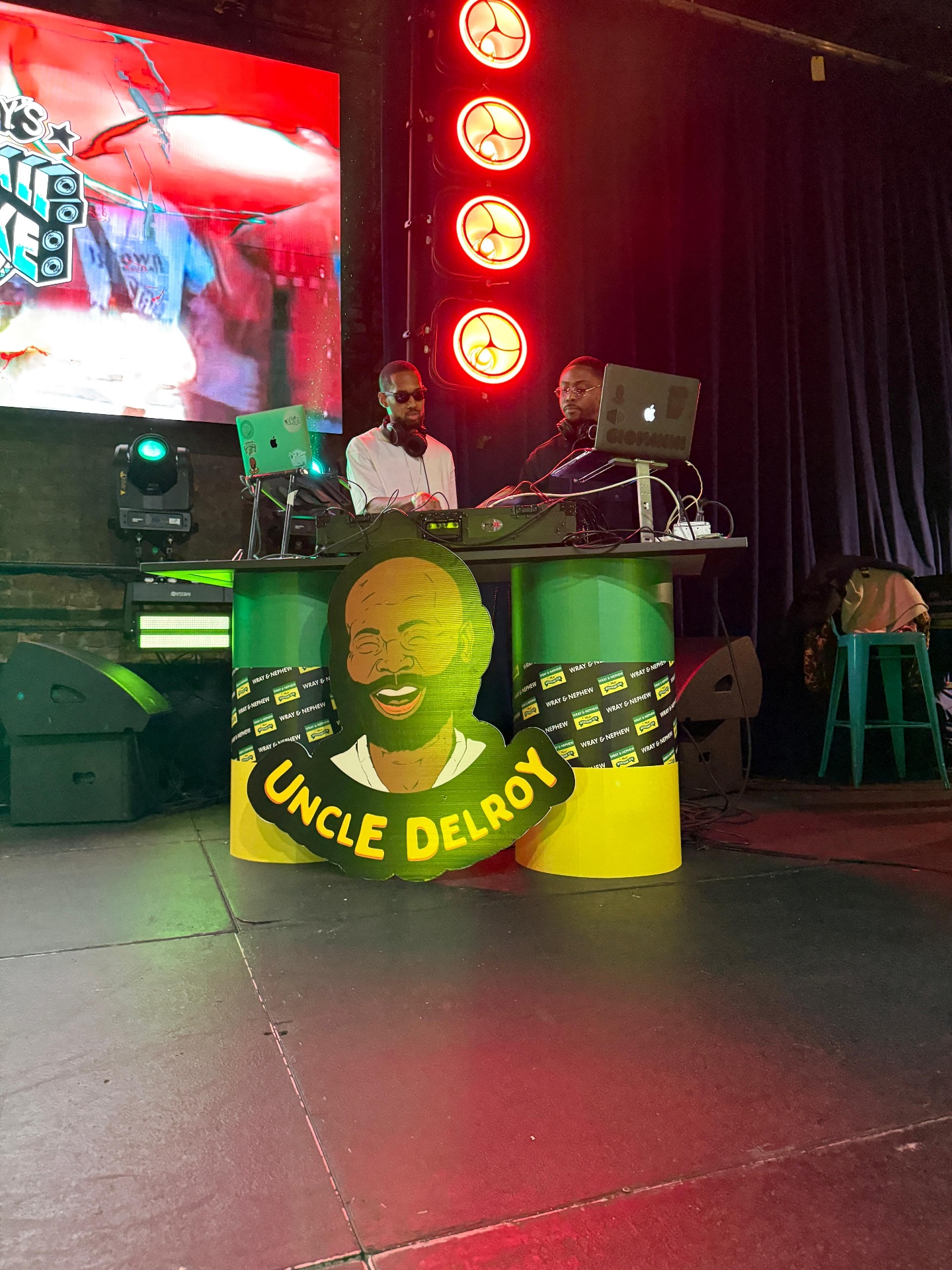 Custom Uncle Delroy DJ riser cutout in front of the DJs onstage